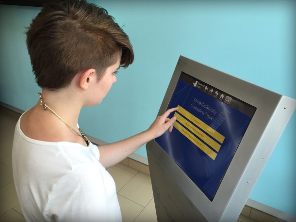 Anna Gibbons, an undergraduate public health major and member of the Drexel student organization Active Minds, which focuses on promoting mental health and wellness, demonstrates use of the mental health screening kiosk.